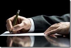 Businessman writing a letter or signing