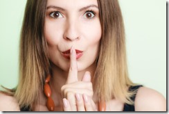 Woman asking for silence with finger on lips